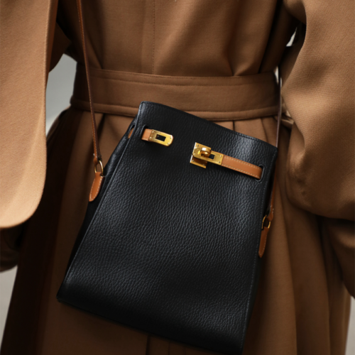 Black and Gold Kelly Sport Bag Hermès Vintage, Model, chosen by Semaine Tastemaker Charlotte Chesnais.